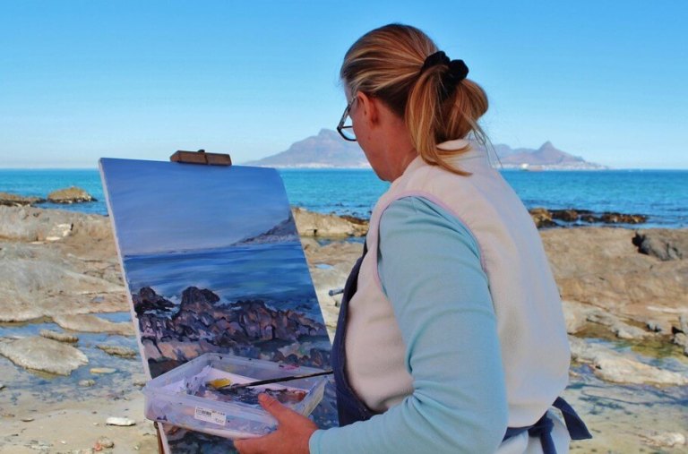 High-achieving professional woman reflecting on whether motivation is driven by fear of failure or personal values as she completes her art exhibit project in Austin, Texas.