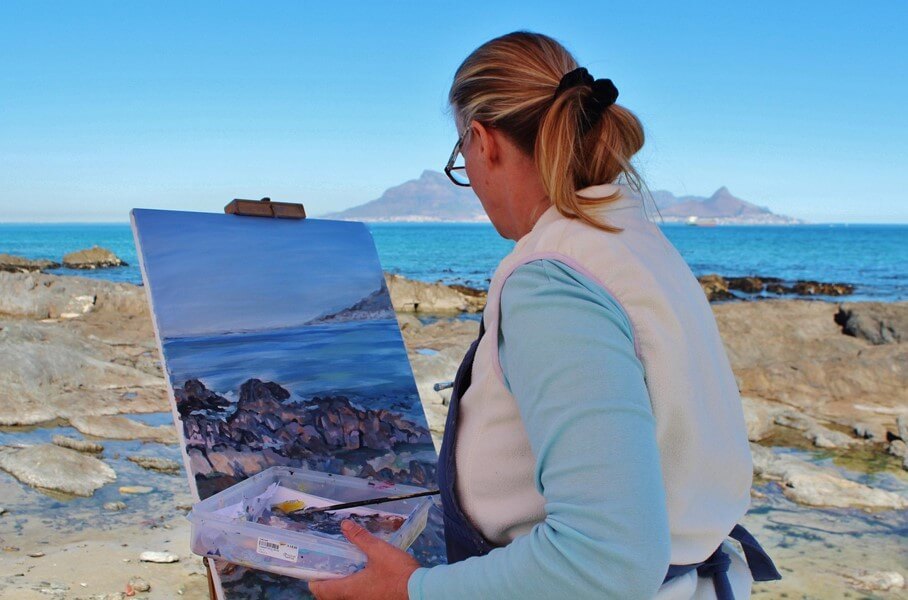 High-achieving professional adult reflecting and painting while learning from setbacks and developing a growth mindset to overcome perfectionism and self-doubt.