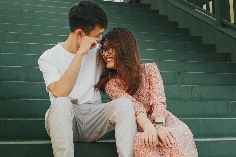 High-achieving couple sitting together, showing emotional connection, trust, and secure attachment.