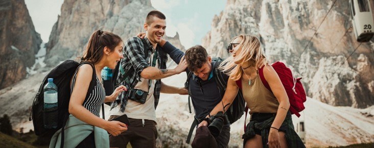 Group of friends laughing together on a hike, representing connection, healing, and overcoming loneliness and social anxiety. Loneliness and social anxiety therapy in Austin, TX.