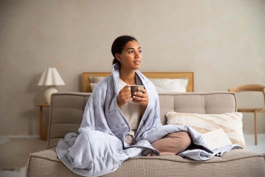Professional woman in Austin, TX in her 30s peacefully relaxing before sleep to reduce anxiety while having a cup of tea.